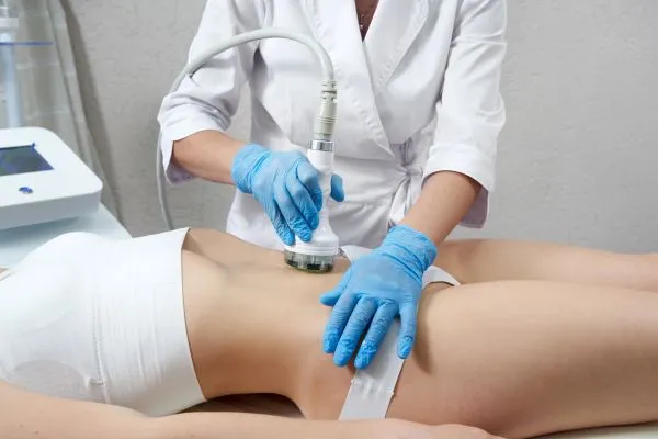 Lost the Weight but Not the Loose Skin? 2 woman having HIFU treatment on her stomach to combat loose skin Cirencester following weight loss
